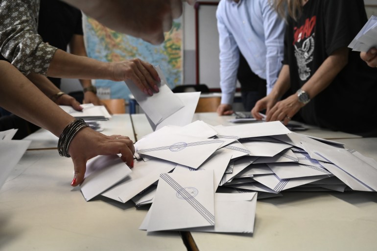 Election officials count votes at a polling station in Thessaloniki, Greece.