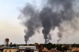 Smoke rises above buildings in Khartoum on May 24, 2023
