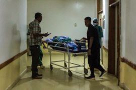 A patient is transported on a gurney at the Medani Heart Centre hospital.