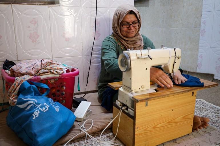 A photo of Sadria using her sewing machine.