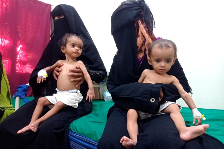 Women hold their malnourished children at Hays Rural Hospital in Hodeida, Yemen, Oct. 11, 2022
