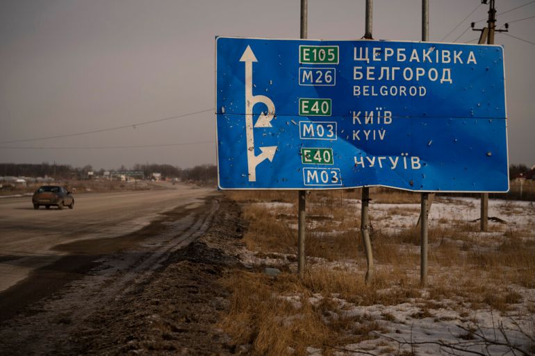 A bullet and shrapnel-riddled signpost on the road to the Russian city of Belgorod
