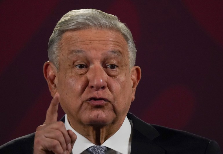 Mexican President Andrés Manuel López Obrador in a close-up shot with one finger pointing up in the air.