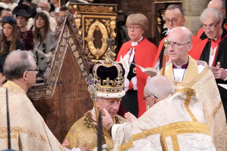 King Charles III sits as he is crowned 