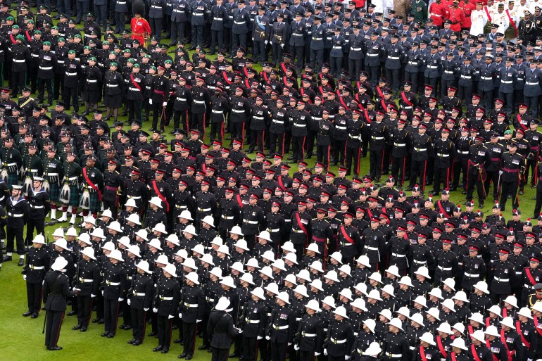Members of the armed forces stand in formation