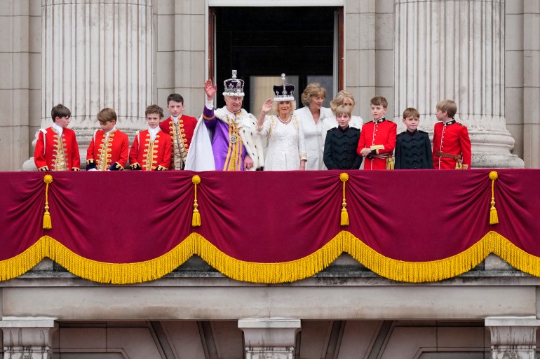 Britain's King Charles III and Queen Camilla wave to the crowds 