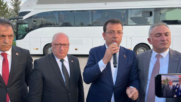 In this handout photo released by Turkish Republican People's Party, CHP, Istanbul Mayor Ekrem Imamoglu, second right, of the main opposition Republican People's Party, CHP, addresses supporters next to his election campaign bus during a rally in Erzurum, Turkey, Sunday, May 7, 2023. More than a dozen people have been detained over violence against an opposition election rally in Turkey's eastern city of Erzurum over the weekend, the country's justice minister said Monday. (CHP via AP)