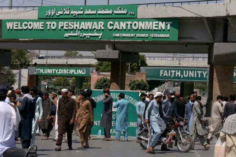 Supporters of Pakistan's former Prime Minister Imran Khan block a road as protest against the arrest of their leader, in Peshawar, Pakistan