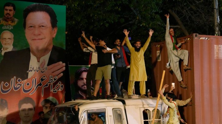 Supporters of former Prime Minister Imran Khan greet their leader upon is arrival at his home in Lahore