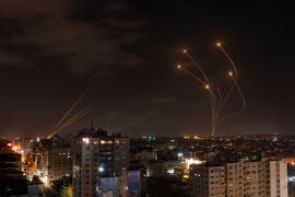 Rockets fired from Gaza and intercepted by Israel's Iron Dome anti-missile system over Israeli skies are seen from Gaza City, Saturday, May 13, 2023. (AP Photo/Fatima Shbair)