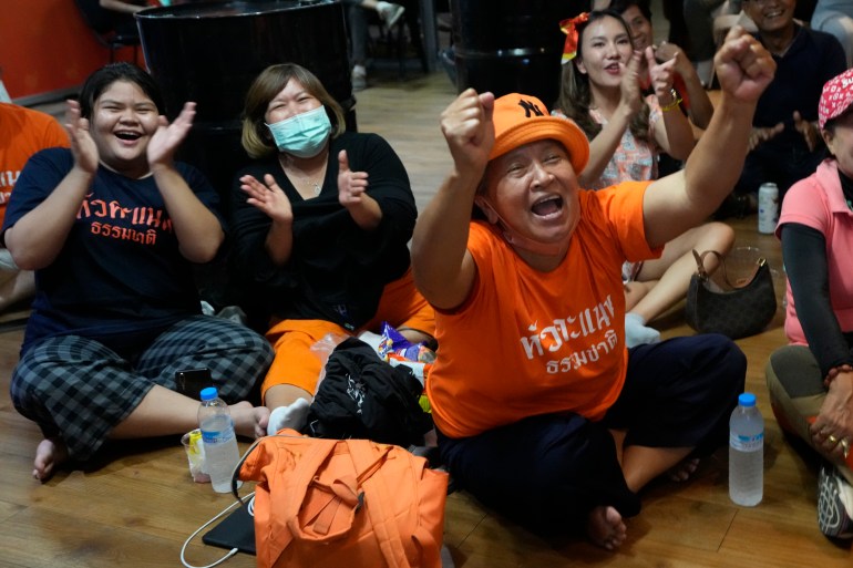 Supporters of Move Forward party cheer as they watch the counting of votes on television at Move Forward Party headquarters in Bangkok, Thailand, Sunday, May 14, 2023.