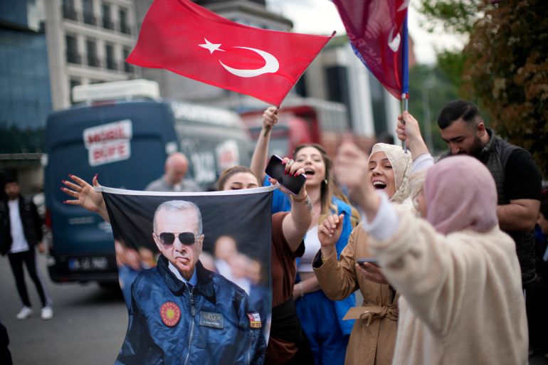 Supporters of President Recep Tayyip Erdogan cheer outside the headquarters of AK Party in Istanbul