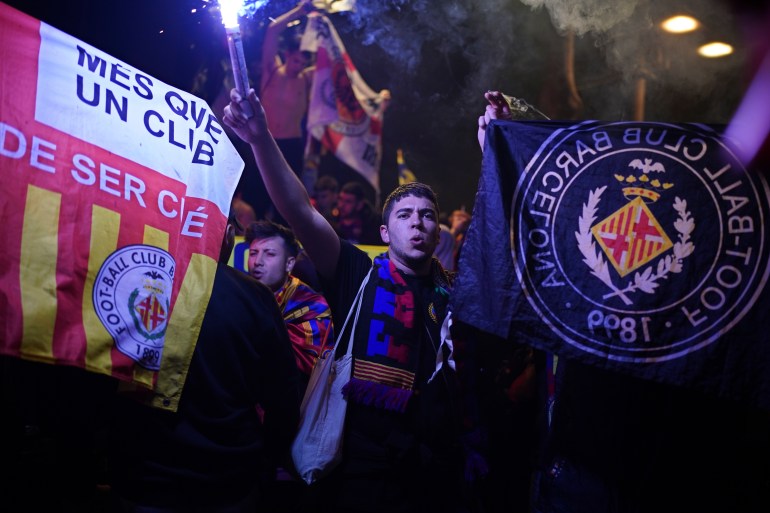 Barcelona fans celebrate in the street after their team won the Spanish La Liga championship by beating crosstown rivals Espanyol in Barcelona