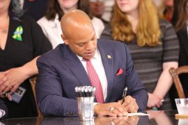 Maryland Governor Wes Moore signs one of several gun-control measures during a bill-signing ceremony on Tuesday, May 16, 2023, in Annapolis, Maryland.