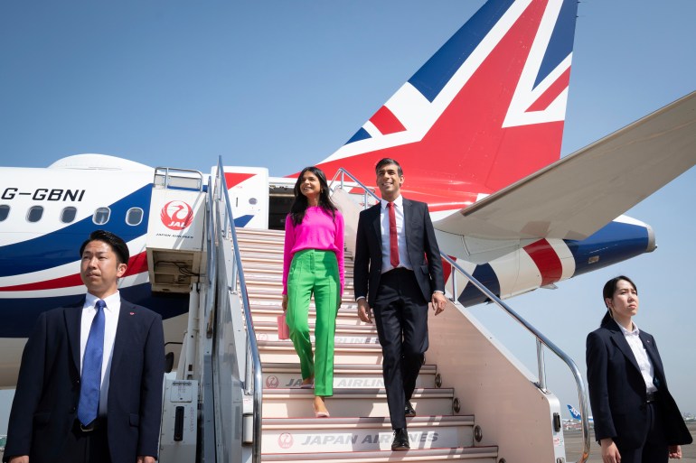 British Prime Minister Rishi Sunak, center right, and his wife Akshata Murty disembark their plane as they arrive at the airport, in Tokyo, Japan, ahead of the G-7 Summit