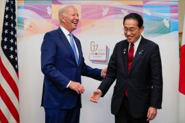 President Joe Biden, left, reacts as he meets with Japan's Prime Minister Fumio Kishida in Hiroshima, Japan