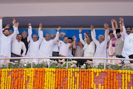 Leaders of different political parties raise their hands after the swearing-in ceremony of Congress party leader Siddaramaiah, fifth right, as Chief Minister of Karnataka in Bengaluru, India, Saturday, May 20, 2023. India's main opposition Congress party wrested control of the crucial southern Karnataka state from Prime Minister Narendra Modi's Hindu nationalist party last week that boosted its prospects ahead of national elections due next year. (AP Photo/Aijaz Rahi)