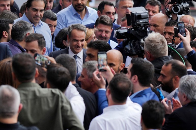 Mitsotakis surrounded by supporters upon arriving at the headquarters of his party in Athens, Greece.