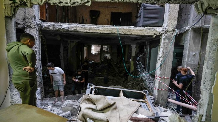 Palestinians inspect a damaged building following an Israeli army raid in the Balata refugee camp near the West Bank town of Nablus