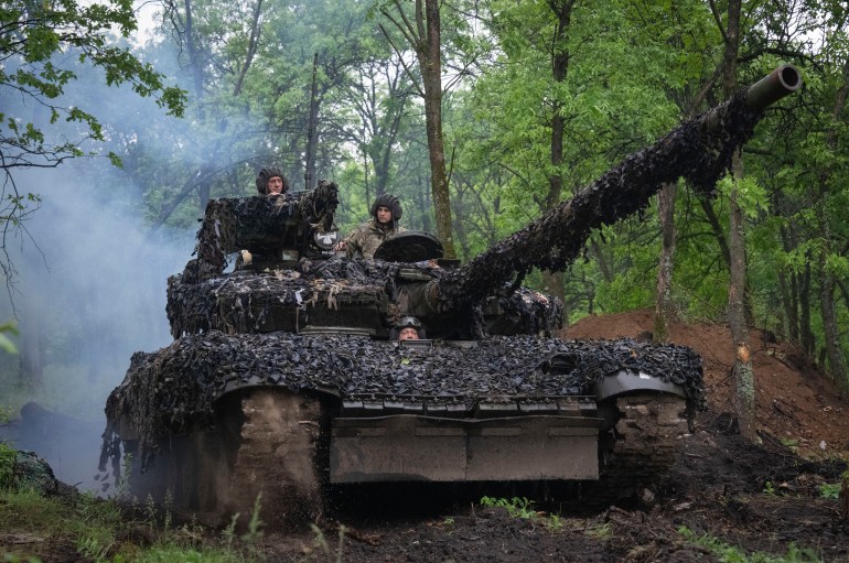 Ukrainian soldiers on a tank ride along the road towards their positions near Bakhmut, Donetsk region, Ukraine