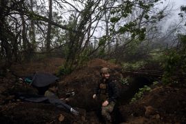 A Ukrainian soldier is seen in a trench at the front line near Bakhmut in the Donetsk region, Ukraine [Libkos/AP Photo]