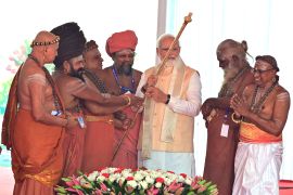 Hindu priests hand over a golden royal sceptre to Indian Prime Minister Narendra Modi to be installed near the chair of the speaker during the start of the inauguration of the new parliament building in New Delhi on May 28, 2023 [AP]