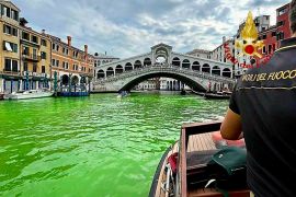 Police in Venice are investigating the source of a phosphorescent green liquid patch [Vigili Del Fuoco/AP]