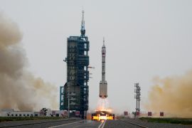 A Long March rocket carrying the Shenzhou-16 spaceship lifts off from the Jiuquan Satellite Launch Center in northwestern China. There are flames beneath the rocket and lots of smoke