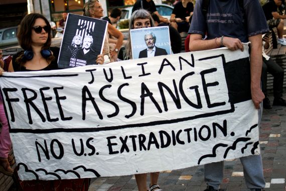 Supporters hold a banner during a protest against the extradition of Julian Assange