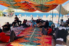 People seek shade in makeshift camps in Port Sudan