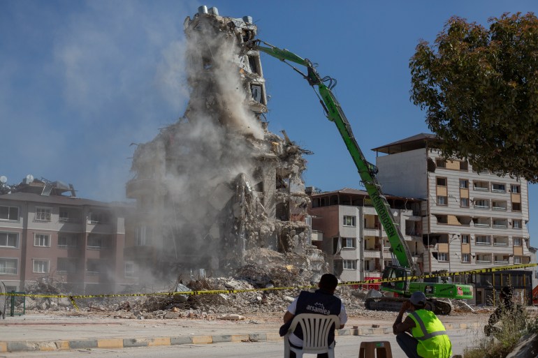 A building damaged by the earthquakes is demolished in Antakya, Turkey.