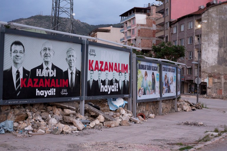 Opposition posters seen on a street in Hatay amid destruction
