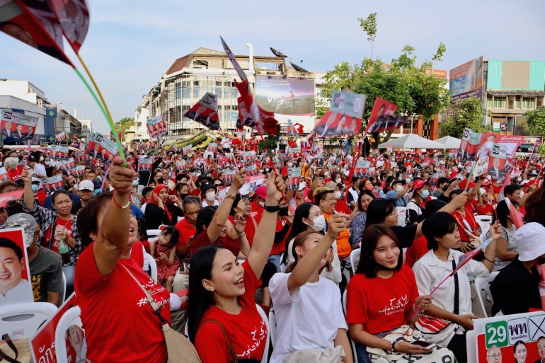 A huge crowd at a Pheu Thai rally in Chiang Mai. They are wearing red shirts and waving flags
