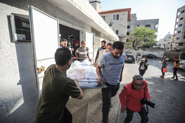 Relatives of Layan Madoukh, 10 year old, carry her body at Al-Shifa Hospital, after she was killed in an Israeli bombing on their home in Al-Sahaba neighbourhood, east of Gaza City [Abedelhakim Abu Riash, Al Jazeera]