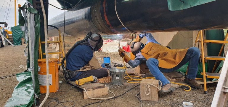 Workers weld a natural gas pipeline in Alexandroupolis, northern Greece. The pipeline will connect an offshore Floating Storage and Regasification Unit (FSRU) to the Greek gas grid