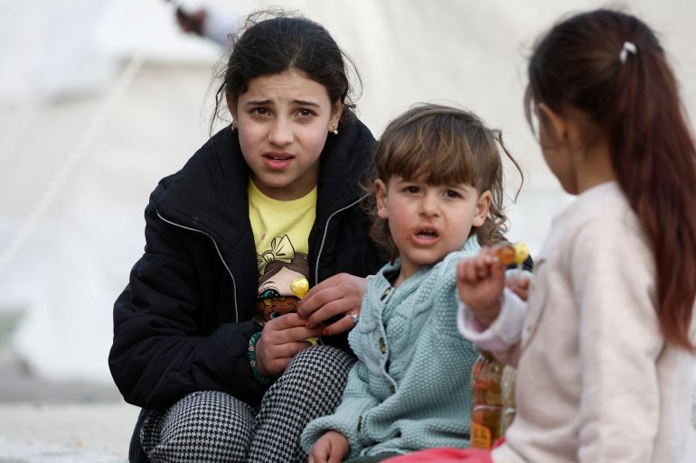 Children look on at an internal displacement camp at the Yeni Hatay Stadyumu in the aftermath of a deadly earthquake in Hatay, Turkey, February 10, 2023. REUTERS/Benoit Tessier