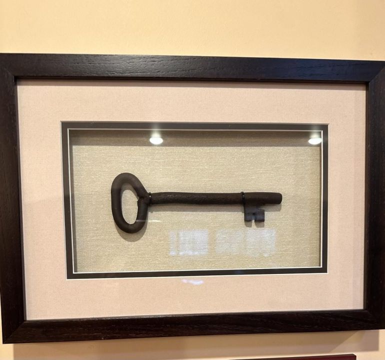 The key to Leila's childhood home framed in her Los Angeles home