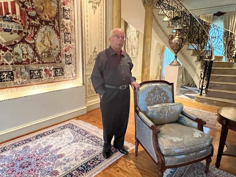 Michael Kardoush stands in his home in the US