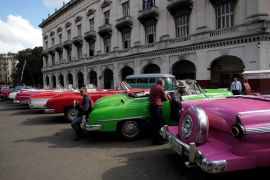 Drivers stand near their vintage cars waiting for clients in Havana ON December 17, 2014. The decades-old US embargo against Cuba has devastated the country&#39;s economy and brought hardship, but has failed to bring regime change [Stringer/Reuters]