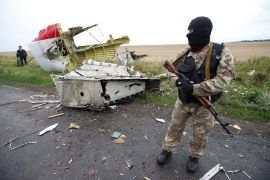 A pro-Russian separatist stands at the crash site of Malaysia Airlines flight MH17, near the settlement of Grabovo in the Donetsk region, July 18, 2014. The Dutch are due to announce on Wednesday 28 September the long-awaited results of an investigation with Australia, Malaysia, Belgium and Ukraine into the July 17, 2014 downing of the flight. REUTERS/Maxim Zmeyev/File Photo FROM THE FILES PACKAGE - SEARCH "FILES MH17" FOR ALL 20 IMAGES