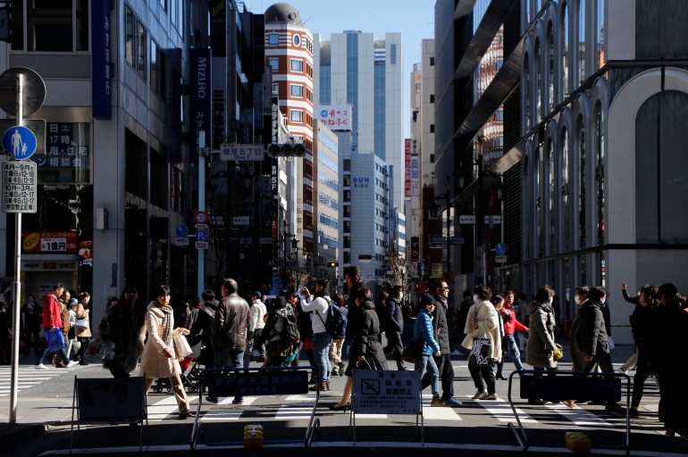 People walk on a street at Tokyo's Ginza shopping district, Japan, February 12, 2017. Picture taken February 12, 2017. REUTERS/Toru Hanai TPX IMAGES OF THE DAY