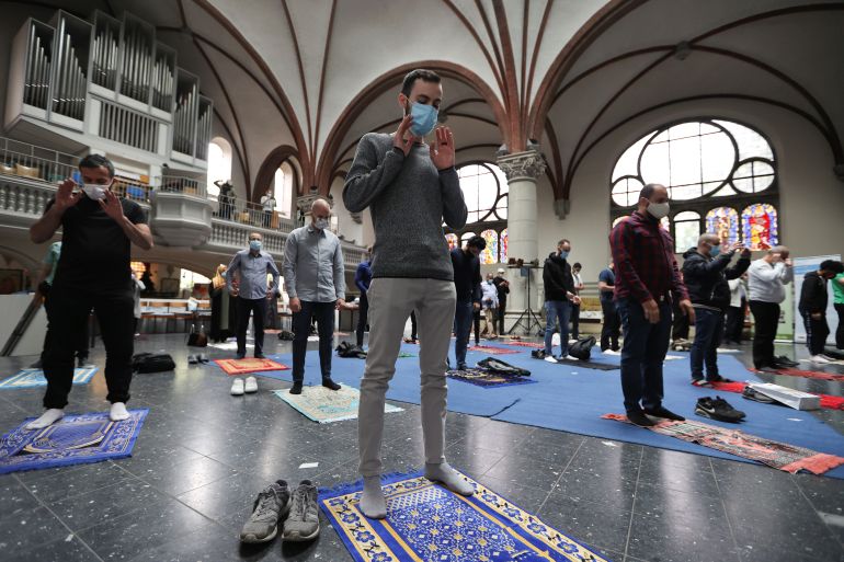 Muslims pray inside the evangelical church of St. Martha's parish, during their Friday prayers, as the community mosque can't fit everybody in due to social distancing rules, amid the coronavirus disease (COVID-19) outbreak in Berlin, Germany, May 22, 2020. REUTERS/