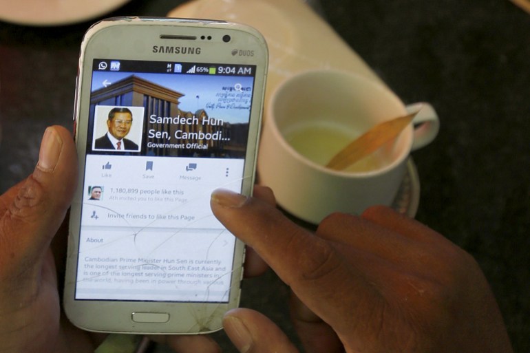 FILE PHOTO: A person uses a smartphone to look at the Facebook page of Cambodia's Prime Minister Hun Sen, during breakfast at a restaurant in central Phnom Penh, Cambodia October 7, 2015. Cambodia's Prime Minister Hun Sen is taking a belated leap into the digital age in a bid to court young, urban voters as he tries to fend off unprecedented competition from the opposition after three decades in power. The former Khmer Rouge soldier has started to enthusiastically embrace Facebook for the first time, coming round to the platform after almost losing a 2013 election when the opposition won a surge of support online. Hun Sen's Facebook, which how has 1.2 million "likes", carries images and videos of new infrastructure and credits him with Cambodia's speedy economic development. To match story CAMBODIA-SOCIALMEDIA/ Picture taken October 7, 2015. REUTERS/Samrang Pring/File Photo
