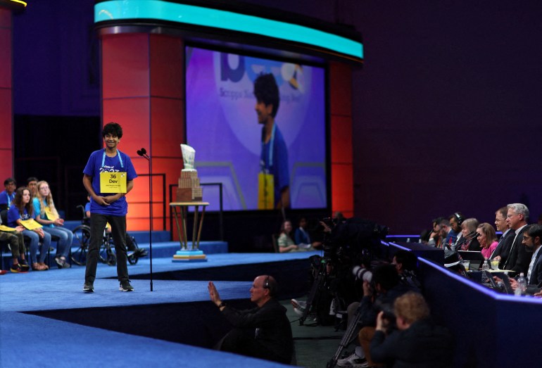 Dev Shah, 14, smiles after spelling his word right as he competes in the semifinals of the Scripps National Spelling Bee