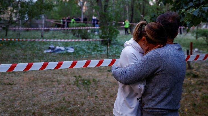 Local residents embrace near to where a person was killed - during a Russian missile attack - at a municipal medical clinic in Kyiv, Ukraine, on June 1, 2023