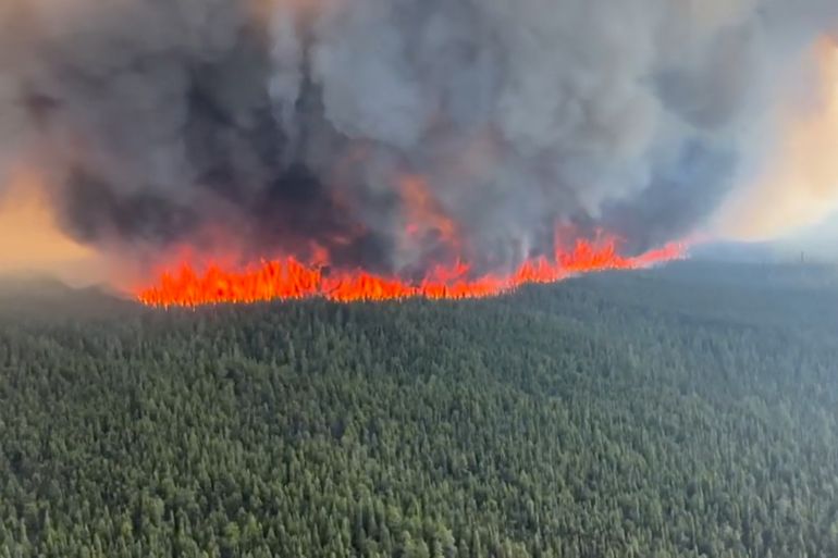 Smoke rises from a wildfire in Tumbler Ridge, British Columbia, Canada,