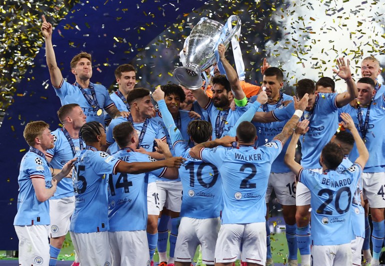 Manchester City's Ilkay Gundogan lifts the trophy as he celebrates with teammates after winning the Champions League. [REUTERS/Matthew Childs]