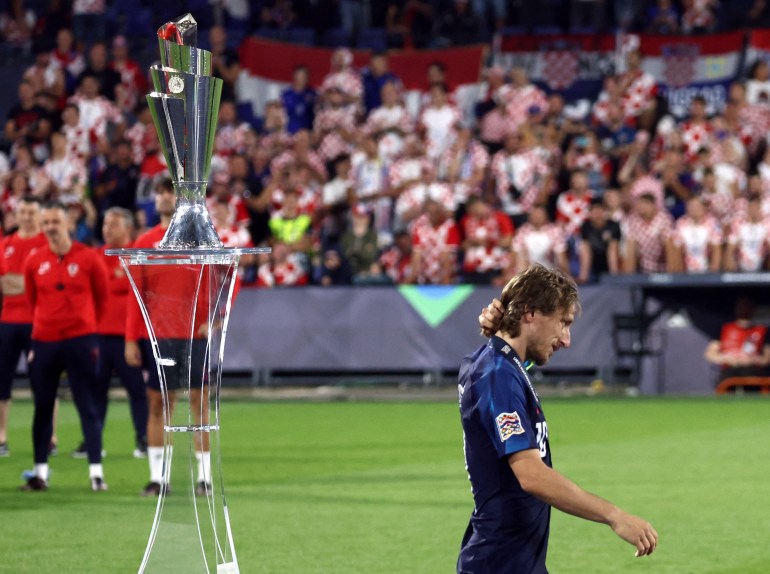Croatia's Luka Modric walks past the trophy looks dejected after losing the penalty shootout and the UEFA Nations League