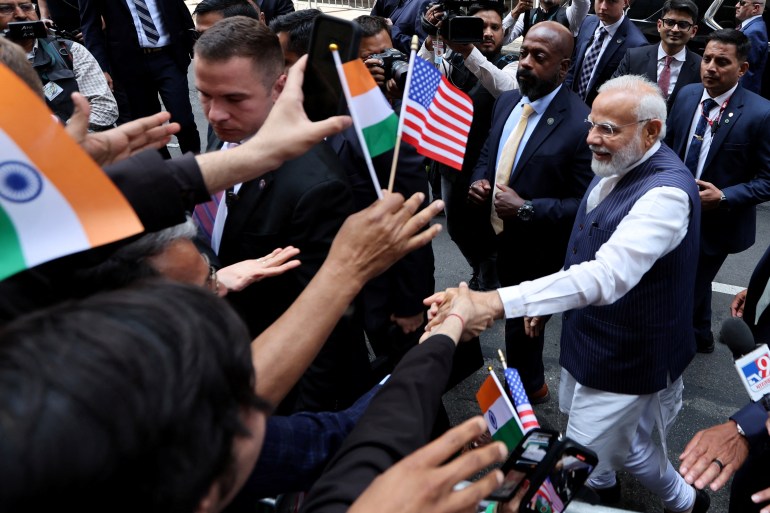 Indian Prime Minister Narendra Modi greeting supporters in New York. Some are waving US and Indian flags.