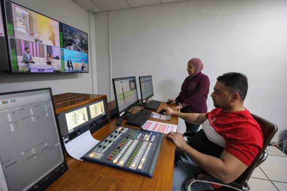 employees work at the studio of 'Al-Syriania' television channel in Baghdad.